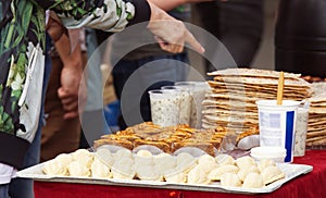 Customer at farmers market buying Azerbaijani specialities