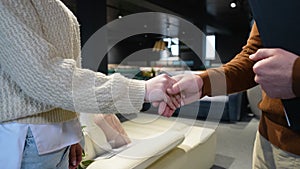 Customer And Female Buyer Handshake In Furniture Store