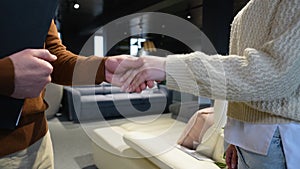 Customer And Female Buyer Handshake In Furniture Store