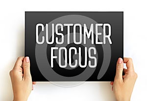 Customer Focus - strategy that puts customers at the center of business decision-making, text concept on card