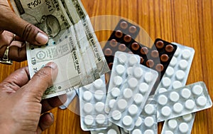 Customer giving money to buy drug at drugstore pharmacy. Close up view. Various capsules, tablets, Pills in medicine shop on table