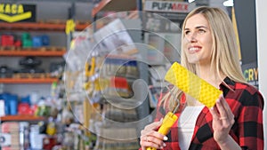 Customer having fun choosing a yellow brush at a retail store