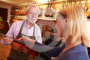 Customer Leaving Violin For Repair In Shop