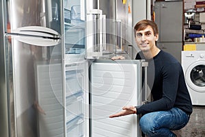 Customer looking at modern fridges