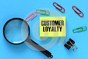 CUSTOMER LOYALTY words on a small yellow card and blue background