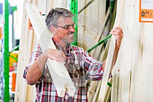 Customer in lumber department of hardware store