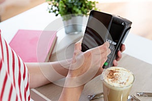 Customer making wireless or contactless payment using smartphone, nfc payment