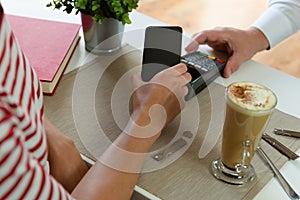 Customer making wireless or contactless payment using smartphone, nfc payment