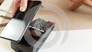 : Customer making wireless or contactless payment using smartphone, nfc payment
