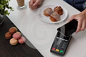 Customer making wireless or contactless payment using smartphone, nfc payment