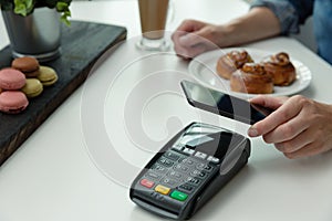 Customer making wireless or contactless payment using smartphone, nfc payment