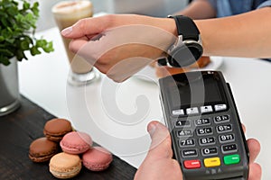 Customer making wireless or contactless payment using smartwatch, nfc payment