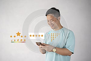 Customer man hand pressing on smartphone screen with gold five star rating feedback icon and press level excellent rank