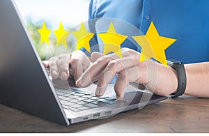 customer man hand typing on keyboard laptop to giving 5 star to review service. Five star rating feedback icon level for