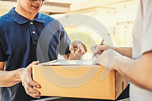 Customer Man signature in clipboard to receive package from professional delivery man at home