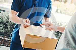 Customer Man signature in Smart Phone to receive package from professional delivery man at home