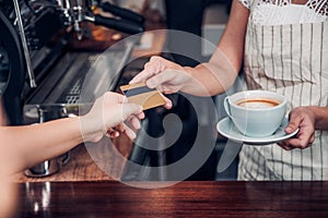 Customer pay coffee drink with credit card to barista,Close up h