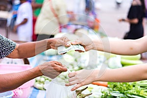 Customer paying bill by cash at market