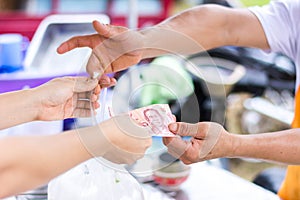 Customer paying bill by cash at market