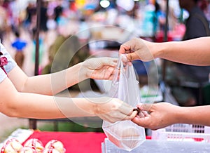 Customer paying bill by cash at market