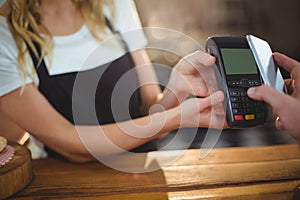 Customer paying bill through smartphone using NFC technology