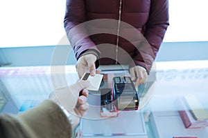 Customer paying card,Woman hand with credit card swipe through terminal for sale