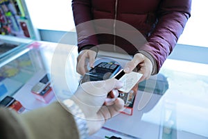 Customer paying card,Woman hand with credit card swipe through terminal for sale