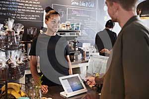 Customer Paying In Coffee Shop Using Credit Card