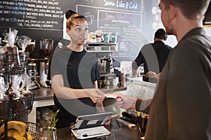 Customer Paying In Coffee Shop Using Credit Card