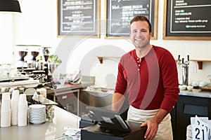 Customer Paying In Coffee Shop Using Touchscreen photo