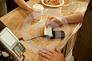 customer paying with credit card in cafe.
