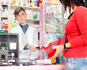 Customer paying with credit card in pharmacy