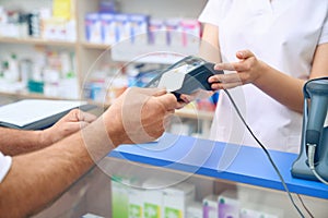 Customer paying for pills using pay pass.