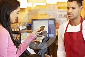 Customer Paying For Shopping At Checkout With Card