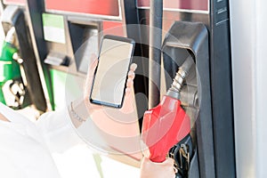 Customer Paying Through Smartphone At Gas Station