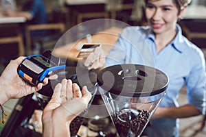 Customer paying for their order with a credit card in a cafe