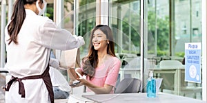 Customer pick up takeout food order from waitress