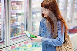 Customer picking a product in the frozen aisle