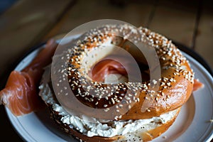 customer with a plate of smoked salmon and cream cheese on a bagel