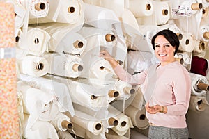 Customer posing near cloth winds