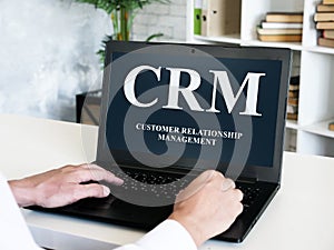 Customer relationship management CRM inscription on laptop screen.