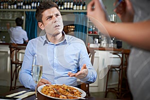 Customer In Restaurant Complaining To Waitress About Food photo