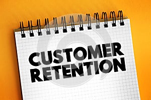 Customer Retention - ability of a company or product to retain its customers over some specified period, text concept on notepad