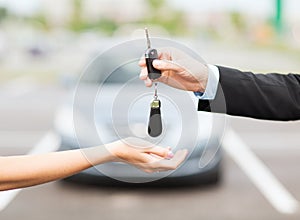 Customer and salesman with car key