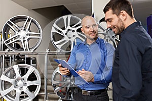 Customer and salesman at car service or auto store