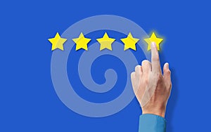 Customer satisfaction Concept. hand Rating five Star on blue background. Satisfied Client and very good Service Review concept