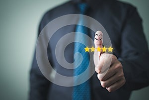 Customer satisfaction concept. Hand with thumb up Positive emotion smiley face icon and five stars with copy space