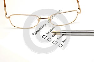 Customer satisfaction survey form with the pen and glasses