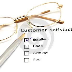 Customer satisfaction survey form with the pen and glasses