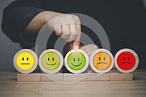 Customer select smile face emoticon for rating. Service rating, feedback, satisfaction concept. Customer service best excellent